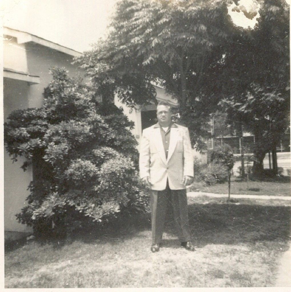 A man standing in front of some trees