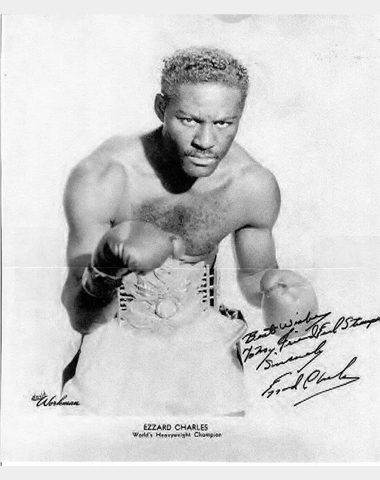 A black and white photo of an african american boxer.