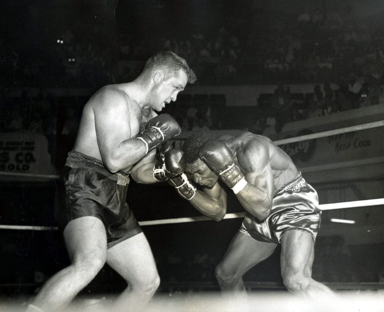 A man in black trunks and gloves is boxing.