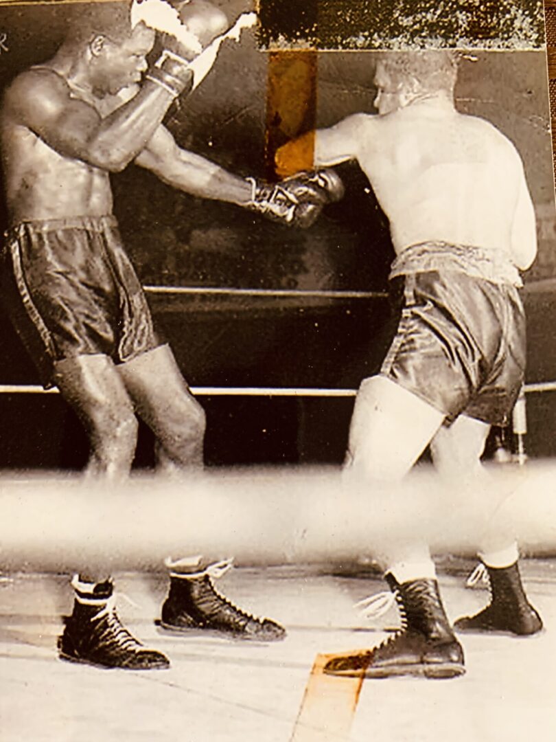 Two boxers in a boxing ring fighting for the title.