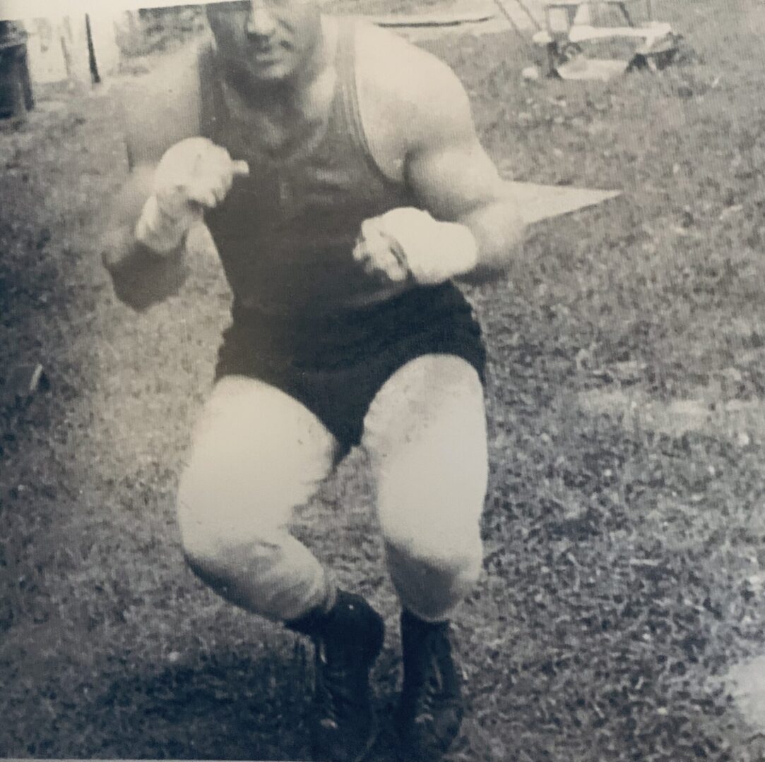 A man in black and white wrestling outfit.