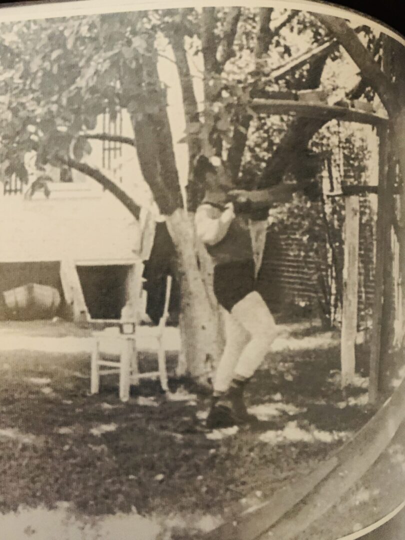 A man in a bathing suit swinging on a swing.