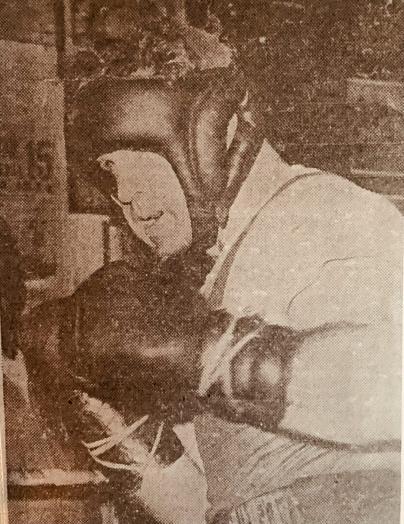 A man wearing boxing gloves and a white shirt.